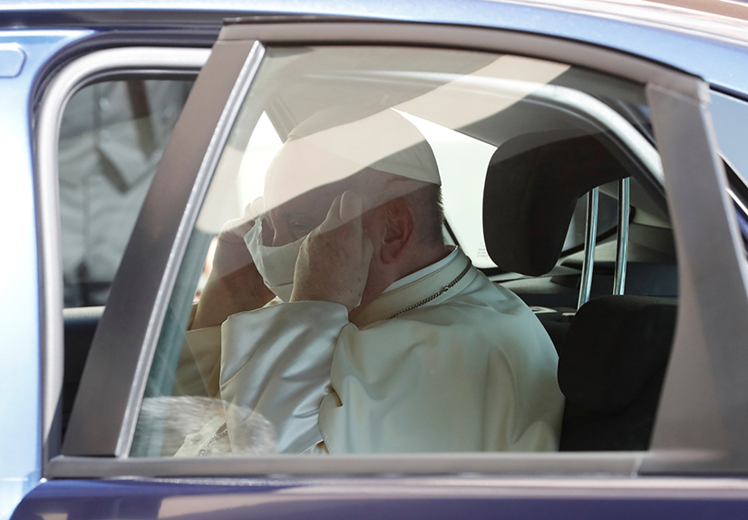 Pope Francis puts on a face mask as he entered the car after leading his weekly general audience at the Vatican Sept. 9.