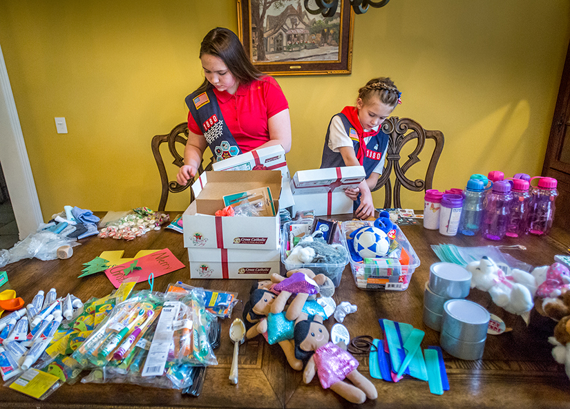 Lauren Morris, left, and her sister Sophia packed Boxes of Joy at their home in Lake St. Louis Oct. 25 as part of a service project for their American Heritage Girls Troop at Immaculate Conception Parish in Dardenne Prairie.