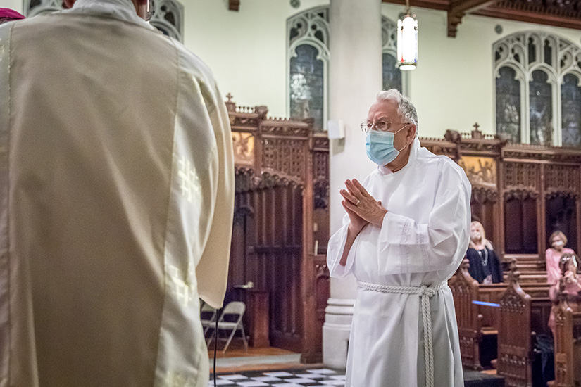 George Mueller, right, was installed as a permanent instituted acolyte for his parish, St. Martin of Tours, by Auxiliary Bishop Mark Rivituso Oct. 21 21 at the St. Vincent de Paul Chapel at the Cardinal Rigali Center.