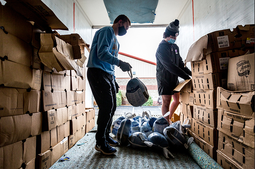 Caleb Kickham and Daniel Rudman, volunteers from Fort Zumwalt West High School, loaded turkeys off the refrigerator truck onto storage boxes for No Hunger Holiday. The annual program, which marks its 30th anniversary, provides full Thanksgiving Day meals for more than 4,000 families in need throughout the St. Louis metro area.