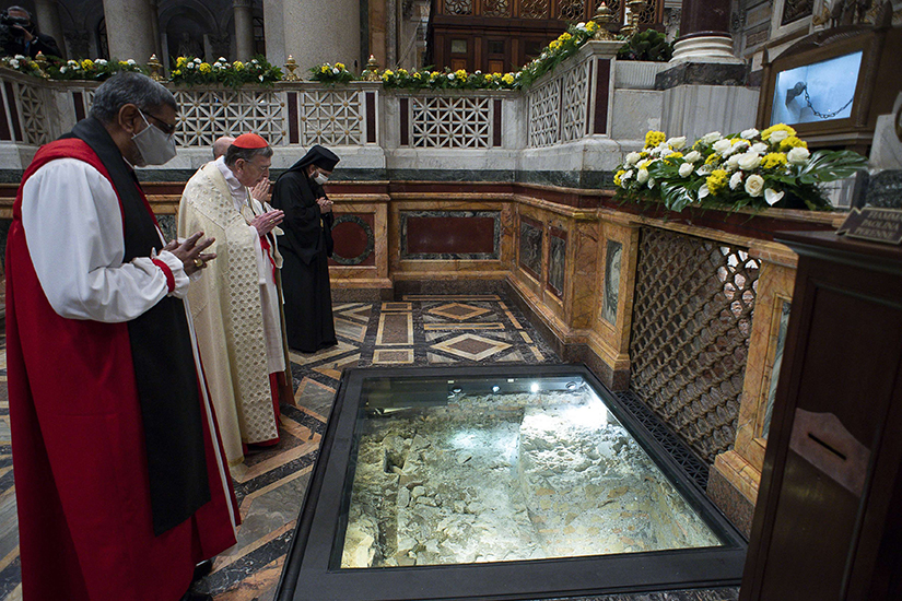 Anglican Archbishop Ian Ernest, director of the Anglican Centre in Rome, Cardinal Kurt Koch, president of the Pontifical Council for Promoting Christian Unity, and Romanian Orthodox Bishop Atanasie Rusnac, vicar for the Diocese of Italy, prayed at the tomb of St. Paul during vespers to close the Week of Prayer for Christian Unity, at the Basilica of St. Paul Outside the Walls in Rome Jan. 25.
