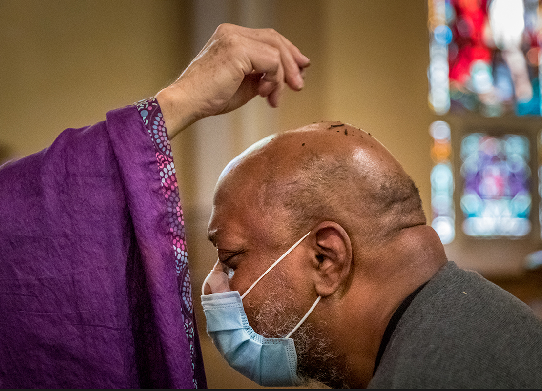 Simeon Layne received ashes via a sprinkle from Msgr. Robert Gettinger at Mass on Ash Wednesday, Feb. 17. Archbishop Mitchell Rozanski permitted pastors discretion whether to impose ashes via sprinkling or the traditional placing them on the forehead, to minimize contact due to the COVID-19 pandemic. The guidance was authorized earlier this year by the Vatican Congregation of Divine Worship and Sacraments.