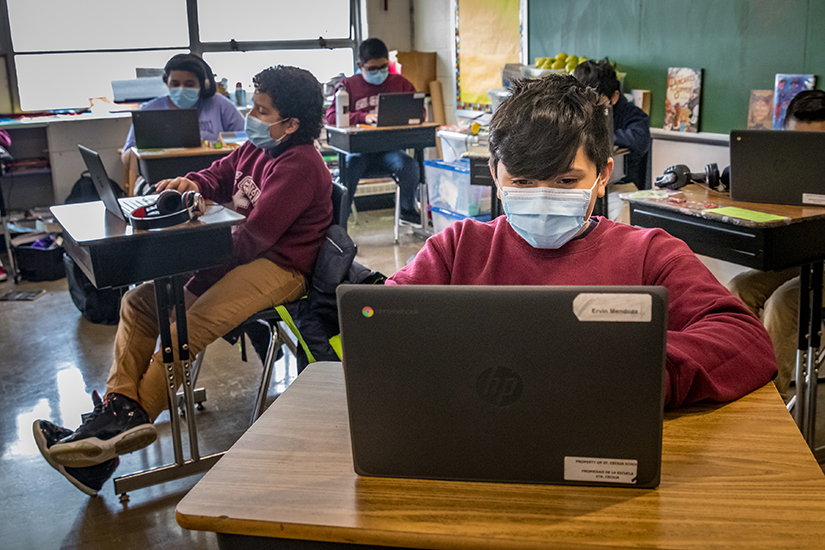 Ervin Mendoza worked on his Chromebook at St. Cecilia in St. Louis, Feb. 11. The school was able to to provide Chromebooks for every student thanks to donations from several sources.