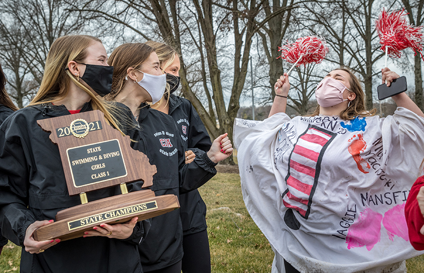 Swim team members Ellie Weckherlin, Ashley Mather and Caroline Burge were cheered on by Abby Eichhorn at a rally and parade at Cor Jesu Academy High School Feb. 26. The rally celebrated the school’s first state championship in swimming.