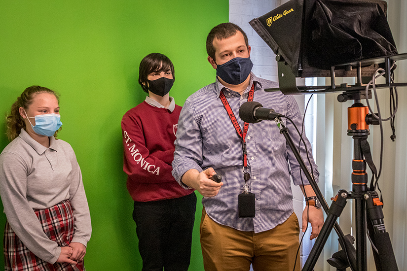 Teacher Nick Yochum advanced the teleprompter as eighth-grade students Zaria Watson and Graham Kelly recorded an interview in the new video studio of the Innovation Lab at St. Monica school in Creve Coeur March 1.