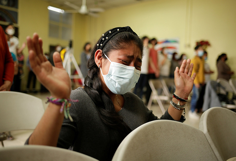 A young migrant from Central America, who was deported from the U.S., prayed during a service inside the Good Samaritan shelter in Ciudad Juarez, Mexico, March 21.