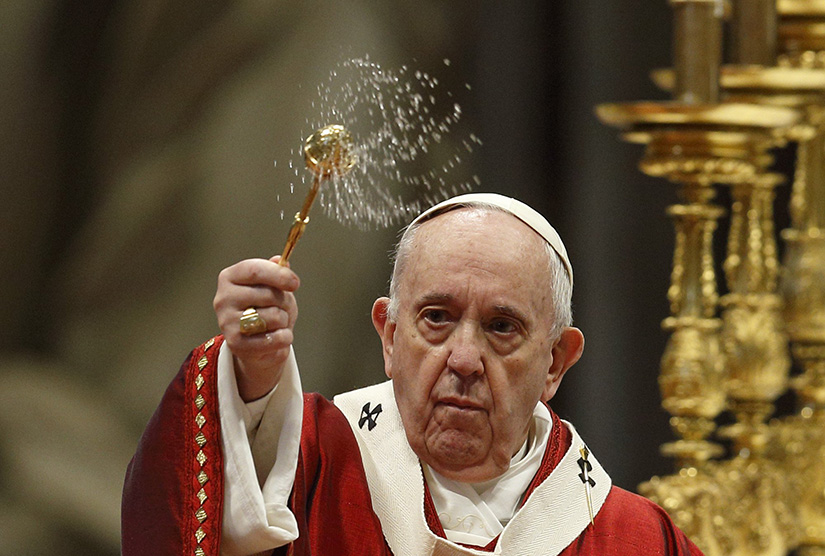 Pope Francis sprinkled holy water as he celebrated Pentecost Mass in St. Peter’s Basilica at the Vatican May 23.