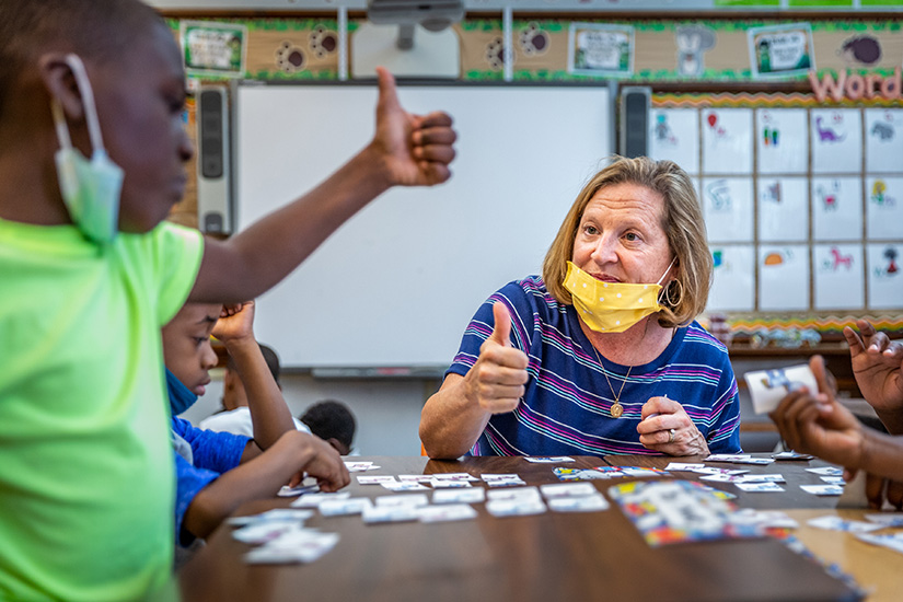 Learning consultant Dede Pitts taught math concepts through a counting game based on unicorns with Shawn McCall and Ashton Murphy at a free summer educational opportunity at St. Louis Catholic Academy in St. Louis on June 17.