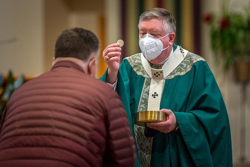 Archbishop Mitchell T. Rozanski distributed the Eucharist as he celebrated Mass before a blessing of the new Rural Parish Clinic-Dental at St. Joseph Church in Cottleville on October 25.
