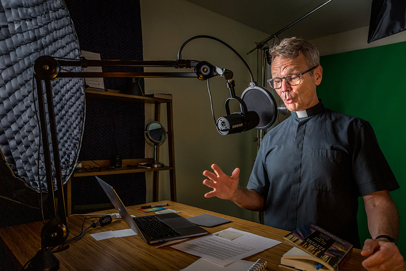 Vincentian Father Ron Hoye, host of The God Minute podcast, recorded in his studio in St. Louis on June 24. The podcast is a 10-minute reflection with Scripture and music that reaches more than 30,000 people a week.