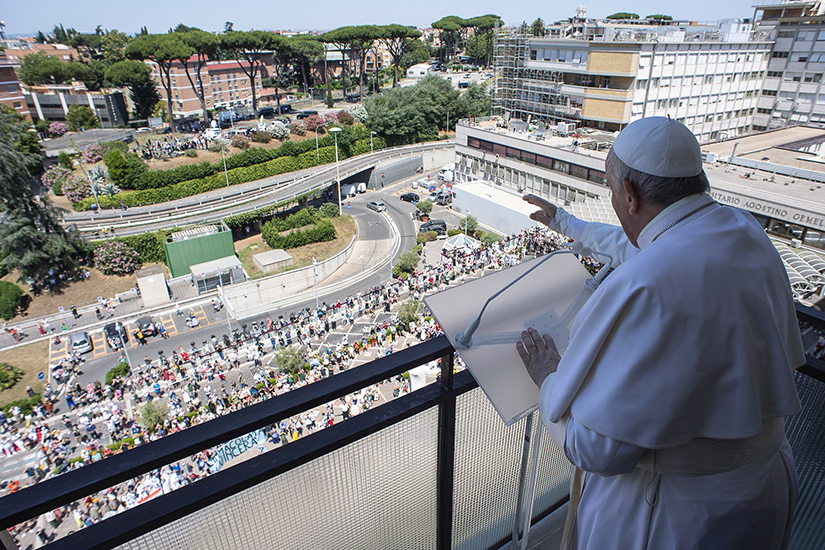 Pope Francis greeted the crowd as he led the Angelus from a balcony of Gemelli hospital in Rome July 11. The pope is at the hospital recovering from scheduled colon surgery.