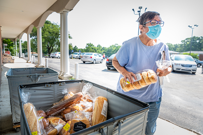 Vicki Carr chose some bread as she received groceries at Feed My People in south St. Louis County on July 26. Food pantries and others service organizations have noticed an increase in the number of people needing assistance.