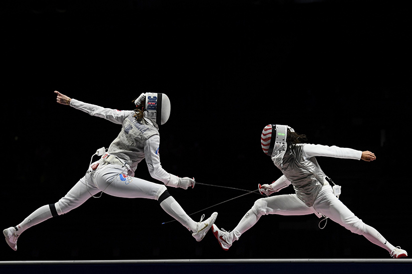 Lee Kiefer of the United States, right, competed against Larisa Korobeynikova of the Russian Olympic Committee in the semifinal of the 2020 Tokyo Olympics women’s individual foil competition July 25. Kiefer won the gold medal in the final.