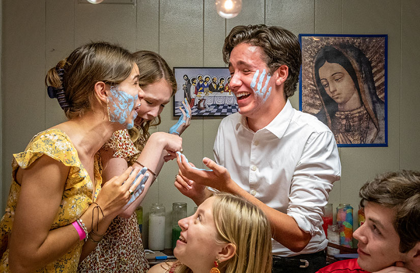 Lauren Bowers and Joseph Donlin laughed after they handprinted each other’s faces during a celebration with recently graduated high school seniors at St. Clement of Rome Parish in Des Peres Aug. 1. Also pictured are Lizzie Hickman and Stephen Wheadon (seated) and Isabel Chapman behind Bowers.