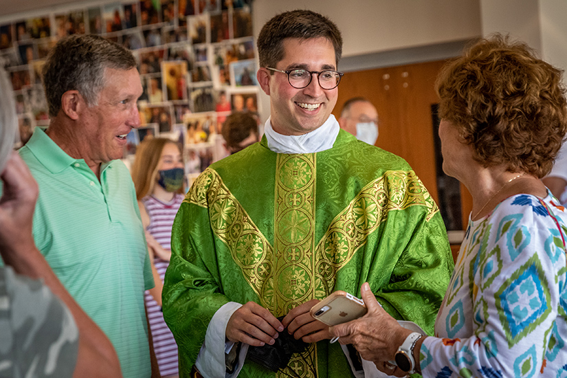 Father Christopher Seiler talked with Paul and Joan Sharkey from St. Gabriel the Archangel Parish after Father Seiler celebrated Mass at his home church, Holy Spirit in Maryland Heights. Father Seiler has been assigned to work in the apostolic nunciature in Angola in southern Africa.