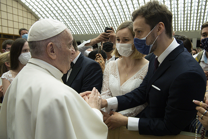 Pope Francis greeted a couple during his general audience in Paul VI hall at the Vatican Aug. 4. It was his first audience since undergoing colon surgery July 4.