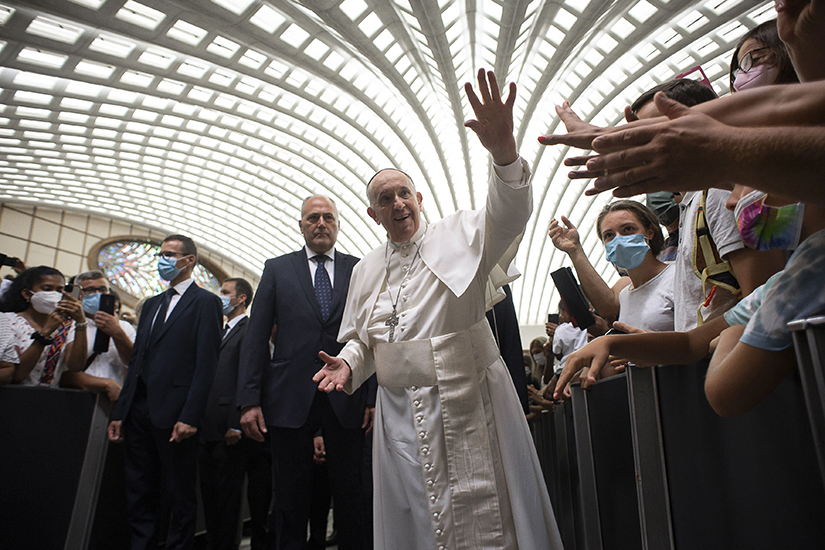 Pope Francis waved during his general audience in the Vatican’s Paul VI hall Aug. 11. The pope continued his series of talks focused on St. Paul’s Letter to the Galatians.