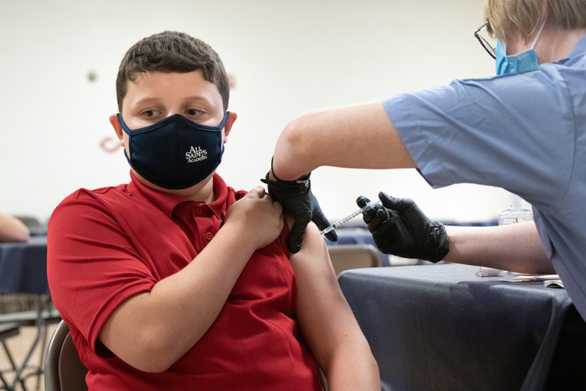 Lucas Wunderlich, a sixth-grade student at All Saints Academy, received the Pfizer vaccine from EMT Kaylee Davis during a clinic held at St. Rose Philippine Duchesne Parish in Florissant Aug. 13. The vaccine clinic was operated by the St. Louis County Health Department.