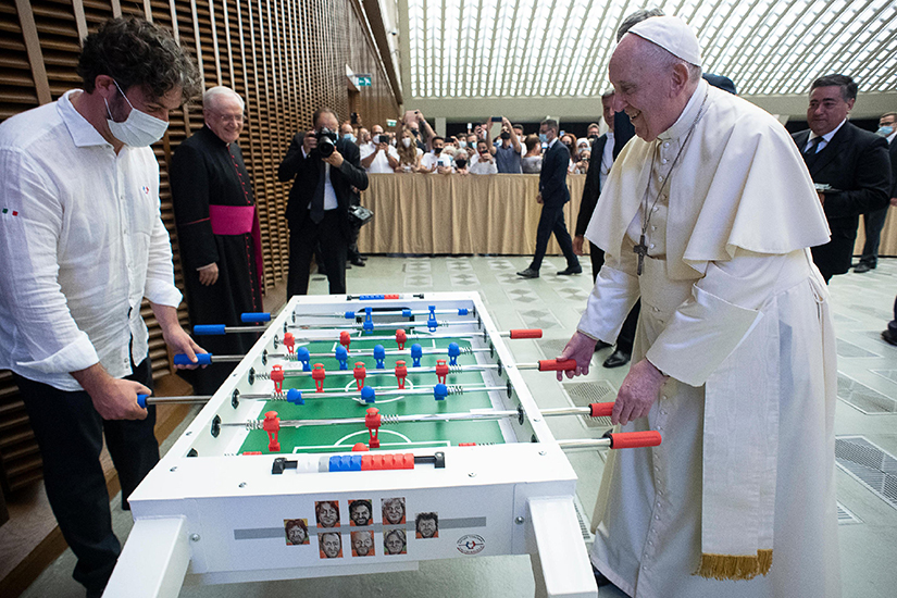 Pope Francis played foosball after leading his general audience in the Vatican’s Paul VI hall Aug. 18.