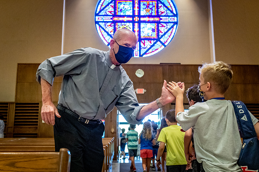 Deacon Dan Henke gave a high five to PSR second-grade student Nolan Riegel at Holy Infant Church in Ballwin on Sept. 13. Deacon Henke said of his ministry as a deacon, “I want to show true joy to others — even when you’re happy or sad, that’s what I want people to see in me.”