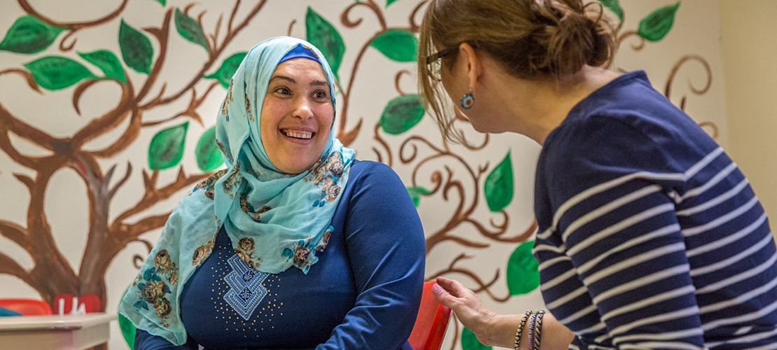 Ursuline Academy teacher Annie Hilmes spoke with Syrian refugee Mona Alfalah at a dinner club organized by Welcome Neighbor STL at Ursuline on April 22. Hilmes assists as a tutor with Welcome Neighbor STL, a group that supports refugee families who have recently settled in St. Louis.