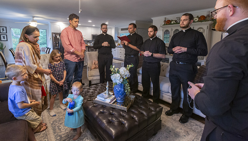 Rita Jo and Chris Horan and their family prayed as they made an act of consecration to the Sacred Heart of Jesus and the Immaculate Heart of Mary, which they had done at their previous home. Several transitional deacons from Kenrick-Glennon Seminary participated in the act of consecration.