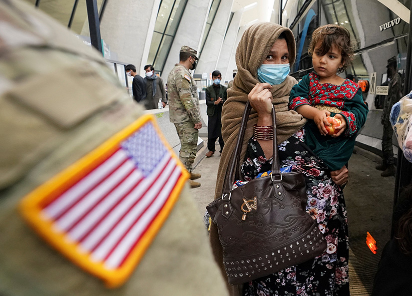 Upon their arrival, Afghan refugees boarded a bus at Dulles International Airport in Dulles, Va., Sept. 1, taking them to a processing center.