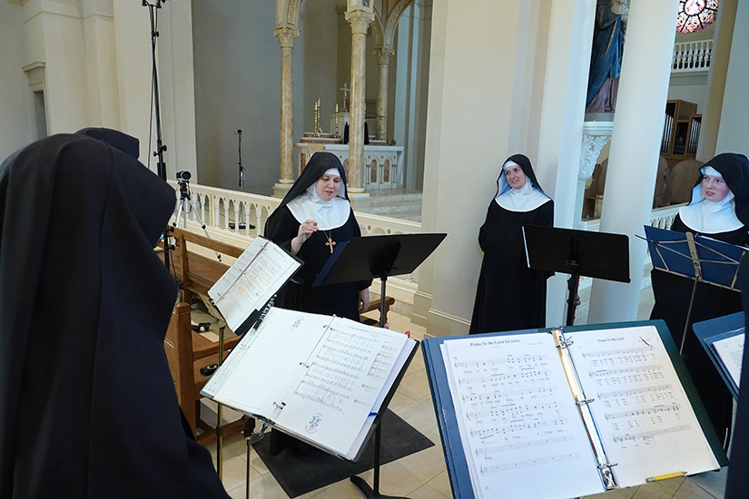 Mother Cecilia, center, prioress of the Benedictines of Mary, Queen of Apostles in Gower, Mo., and other nuns listened to the playback of her recording session for the “Christ the King at Ephesus” album inside the monastery Sept. 23. This is their first album in three years.