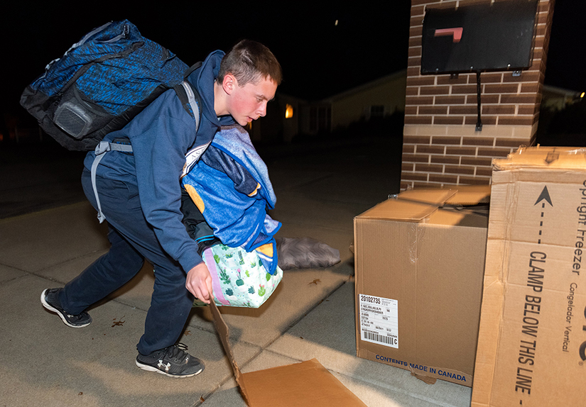 Reed Newbanks organized his belongings outside St. Anthony School while he and other seventh- and eighth-grade students participated in a program that simulates homelessness. They also heard from people who work with people who are unhoused.