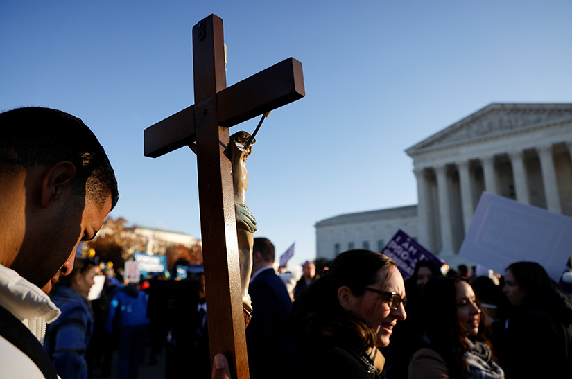 Pro-life activists protested outside the U.S. Supreme Court building in Washington Dec. 1 ahead of the court hearing oral arguments in the case Dobbs v. Jackson Women's Health Organization. The case is an appeal from Mississippi to keep its ban on abortions after 15 weeks of pregnancy. 