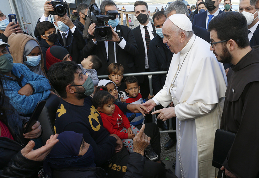 Pope Francis held the hand of a man during a visit with refugees at the government-run Reception and Identification Center in Mytilene, Greece, Dec. 5.
