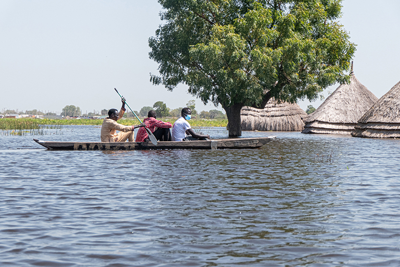 South Sudanese men steered a canoe through floodwaters in Bentiu Nov. 20. Bishop Stephen Nyodho Ador Majwok of Malakal called for support as floods continued to devastate his diocese.