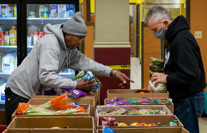 Robert McBride, left, and Robert Gilbert unpacked donated food at the Our Lady of Perpetual Help Food Pantry in St. Louis Dec. 7. The food pantry in the O’Fallon neighborhood of St. Louis has as a mission to welcome and serve people with dignity, respect and hope in the spirit of the Gospel of Jesus Christ.