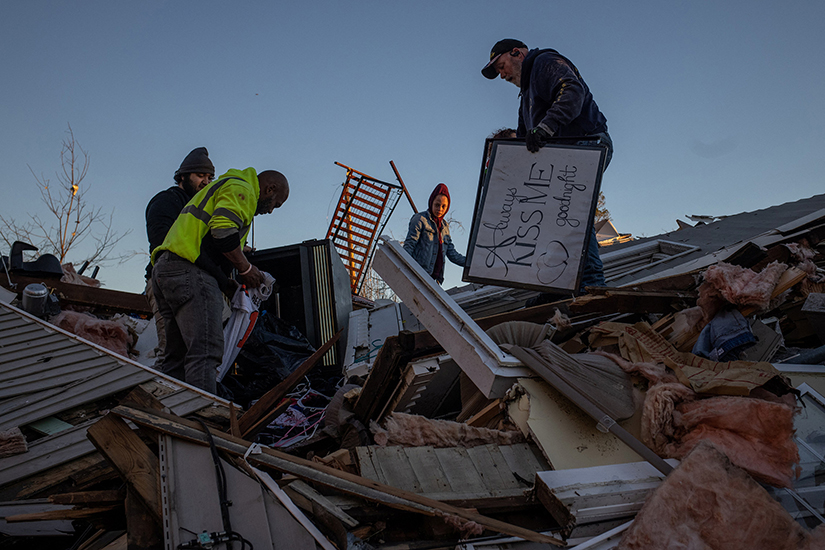 Members of the Weatherbee family salvage their belongings from their destroyed home in Mayfield, Kentucky Dec. 13, in the aftermath of a tornado that ripped through the town.