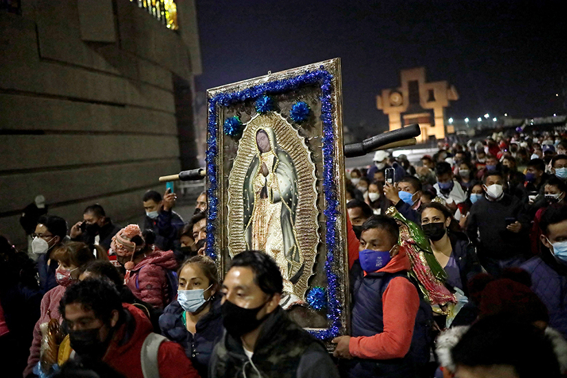 Pilgrims carried an image of Our Lady of Guadalupe outside the basilica in her name in Mexico City Dec. 11, the eve of her feast day. Millions of pilgrims descended on the basilica during the first 12 days of December, renewing a tradition and act of faith common throughout central Mexico.