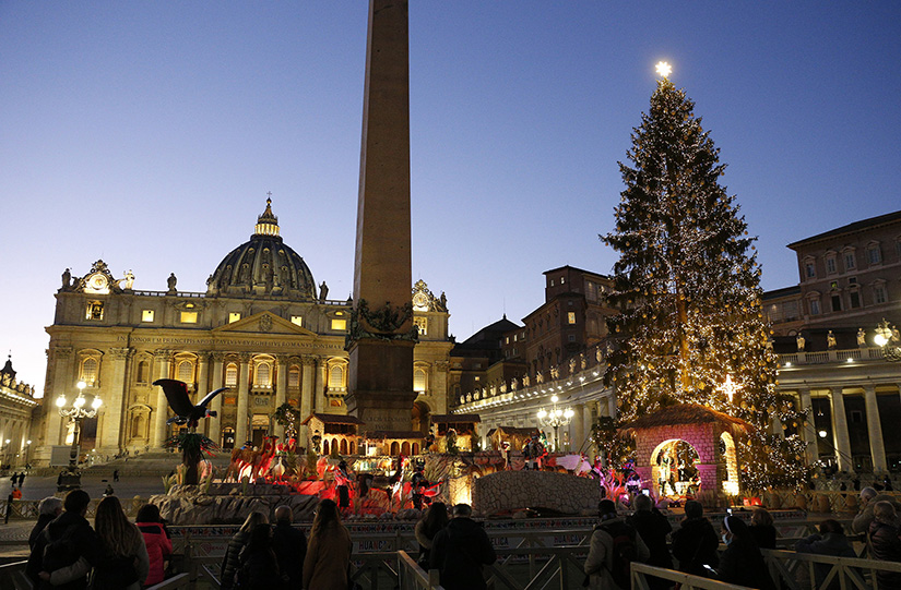 People visited the Nativity scene and Christmas tree in St. Peter’s Square at the Vatican Dec. 17.