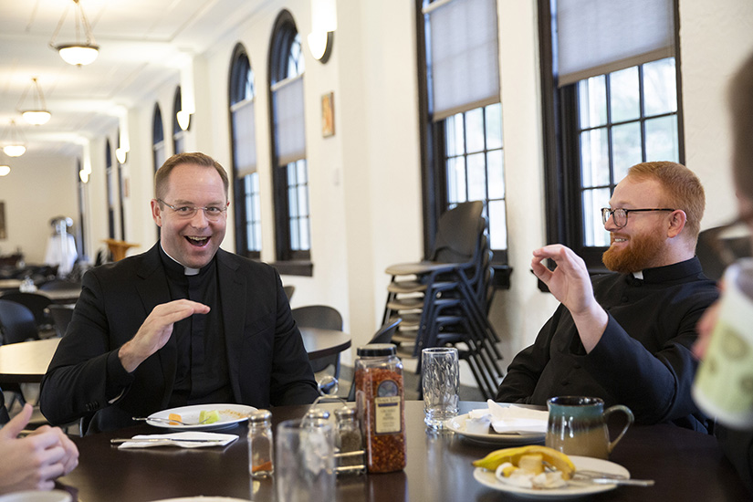 Father Paul Hoesing, left, spoke with seminarians including Deacon Jonathan Tolberd of Wichita, Kansas, while eating breakfast Jan. 19 at Kenrick-Glennon Seminary. Father Hoesing has been named as the next president-rector of the seminary.