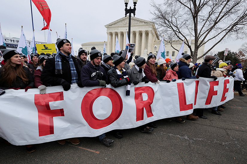 People carried a banner past U.S. Supreme Court building while participating in the 49th annual March for Life in Washington Jan. 21.