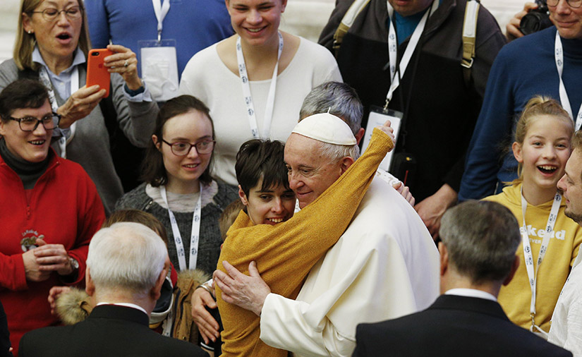 Pope Francis embraced a young woman during his general audience in the Paul VI hall at the Vatican Feb. 9.