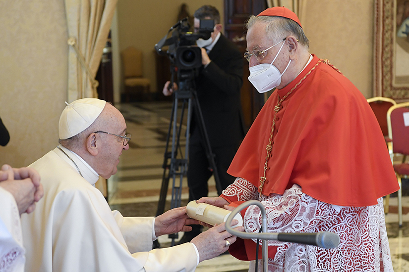 Pope Francis accepted a scroll from Cardinal Giuseppe Bertello during an “ordinary public consistory” for the approval of the canonizations of 10 new saints, at the Vatican March 4. The canonization ceremony for Blesseds Titus Brandmsa, Charles de Foucauld and eight others will take place May 15 at the Vatican.
