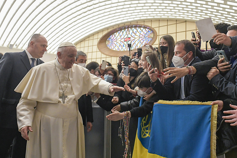 Pope Francis greeted people holding a flag with the Ukrainian national colors and coat of arms at his general audience in the Paul VI hall at the Vatican on March 16.