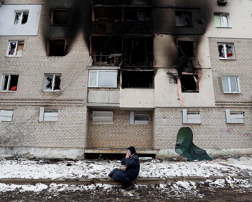 A woman reacted in front of a residential building damaged during the Ukrainian-Russian war in Volnovakha, Ukraine on March 11.