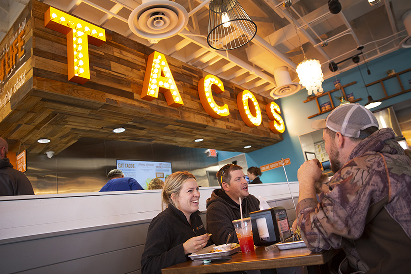 Melanie Ilgenfritz, a parishioner at St. Joseph Parish in Cottleville, ate with her brother, Bradley Bathe, of Cottleville, center, and cousin Adam Molitor, of Wentzville, right, on April 5 at Tacos 4 Life in O’Fallon. The purchase of an entree item at the restaurant results in Tacos 4 Life donating the funds for a meal to Feed My Starving Children.