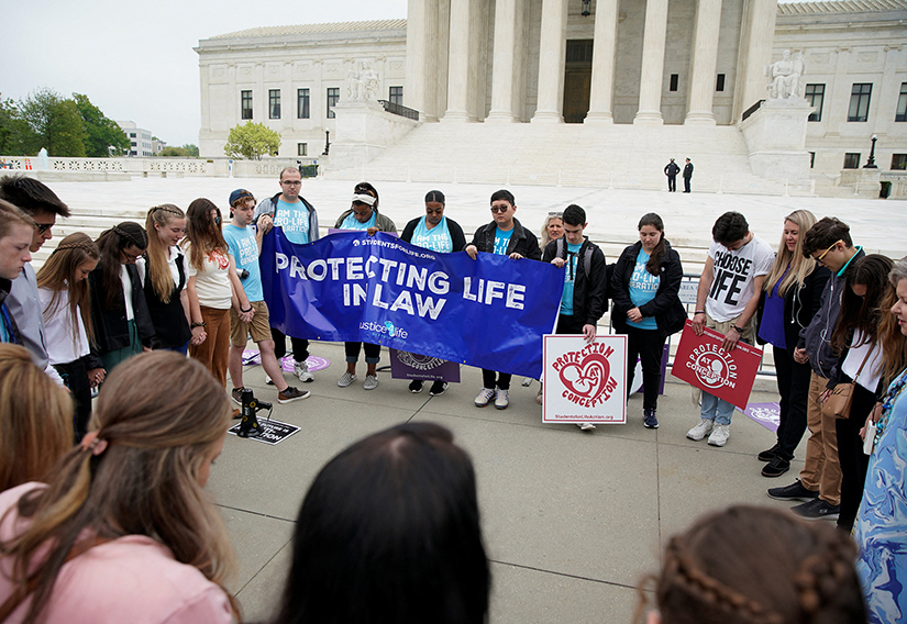 Demonstrators gathered outside the U.S. Supreme Court in Washington May 3 after the leak of a draft majority opinion written by Justice Samuel Alito. The draft, which was confirmed to be authentic but not final, indicated the court could overturn the landmark Roe v. Wade abortion rights decision later this year.