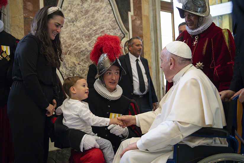 Pope Francis greeted a child during a meeting with new members of the Swiss Guard ahead of their swearing-in ceremony at the Vatican May 6.