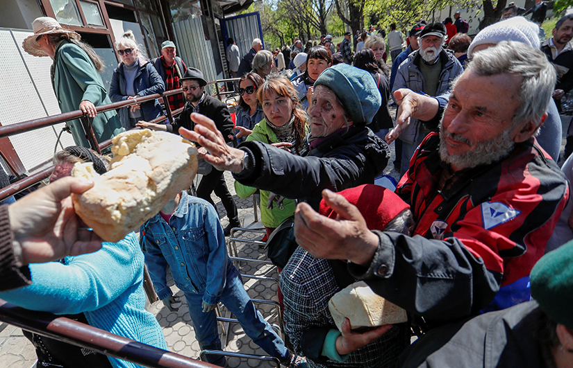 People received bread during the distribution of humanitarian aid in the southern port city of Mariupol, Ukraine, May 8.