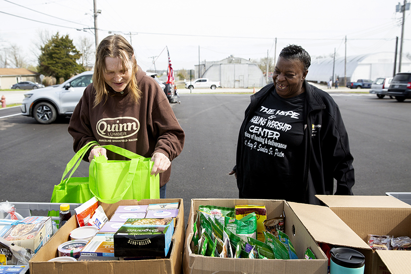 Sandra Palmer, left, and Odette Jamison, both of Truesdale, picked out food from Sts. Joachim and Ann Care Service’s mobile food pantry April 21 at Bruer Park in Truesdale.