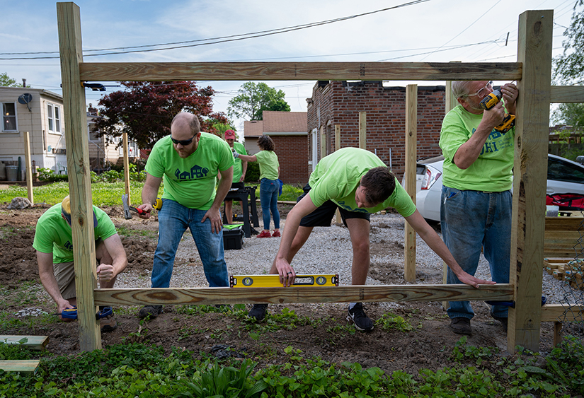 From left, Paul Payne, Charles Allison, Sean Sullivan and David Borgmeyer built a fence in the backyard of a home being rehabilitated by St. Joseph Housing Initiative on May 14 in the Dutchtown neighborhood of St. Louis. The faith-based agency is working to create stronger communities through affordable quality housing for low- and moderate-income families.