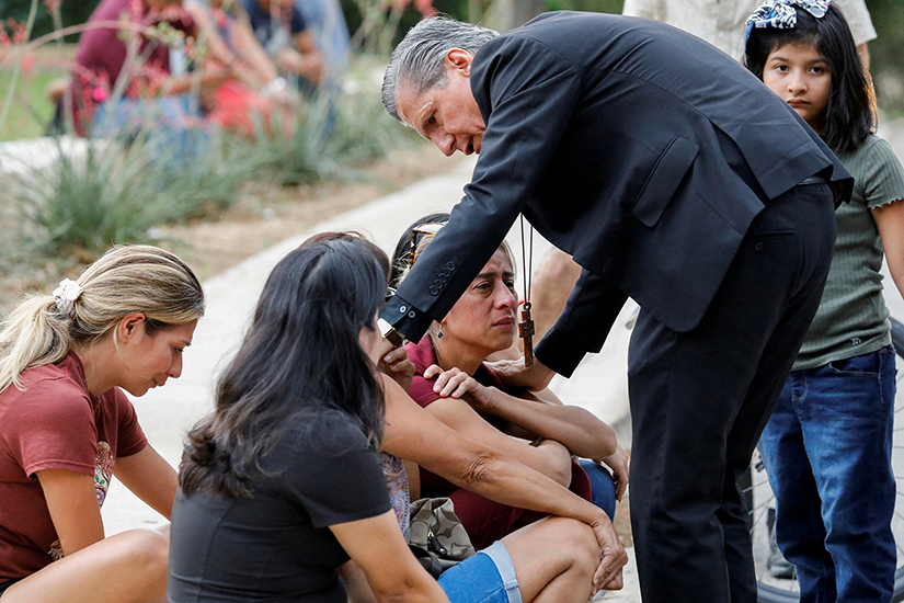 Archbishop Gustavo García-Siller of San Antonio comforted people in Uvalde, Texas, outside the SSGT Willie de Leon Civic Center, where students had been transported from Robb Elementary School after a shooting May 24.