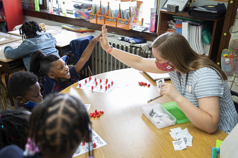 St. Louis Catholic Academy first-grade teacher Julie Gates high-fived London Hubert for getting ‘bingo’ May 24. Gates said, “I tell them, ‘Yes, I care if you can add and subtract, I care if you can read, but I want you to remember that you’re a child of God. I want you to treat others with the same respect you want to be treated with.’ I’m big on respect. And I think that boils down to, if you know Jesus loves you, you have that love to give back to other people.”